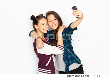 happy teenage girls taking selfie by smartphone happy teenage girls taking selfie by smartphone 47131105