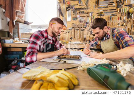 carpenters with tablet and blueprint at workshop carpenters with tablet and blueprint at workshop 47131176