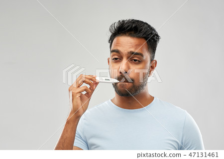 man measuring oral temperature by thermometer man measuring oral temperature by thermometer 47131461