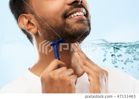 close up of man shaving beard with razor blade close up of man shaving beard with razor blade 47131463