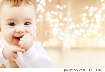close up of sweet baby over christmas lights close up of sweet baby over christmas lights 47131465