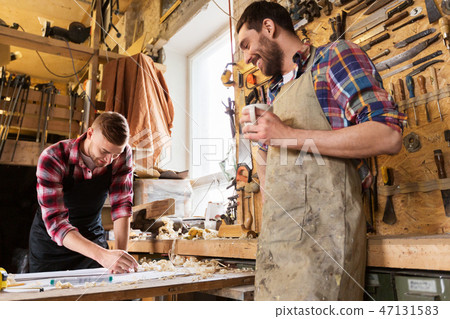 carpenters with ruler and coffee at workshop 47131583
