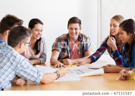 group of smiling students with blueprint group of smiling students with blueprint 47131587