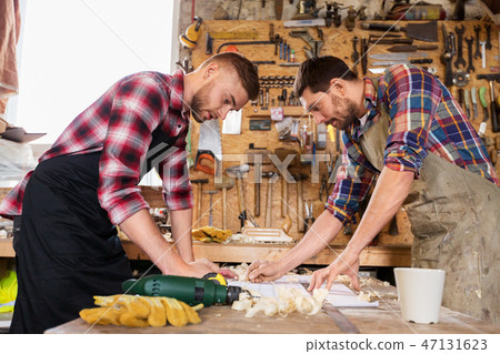 carpenters with ruler and blueprint at workshop carpenters with ruler and blueprint at workshop 47131623