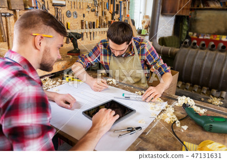 carpenters with tablet and blueprint at workshop carpenters with tablet and blueprint at workshop 47131631
