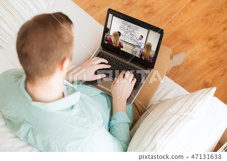 man watching webinar on laptop computer at home 47131638