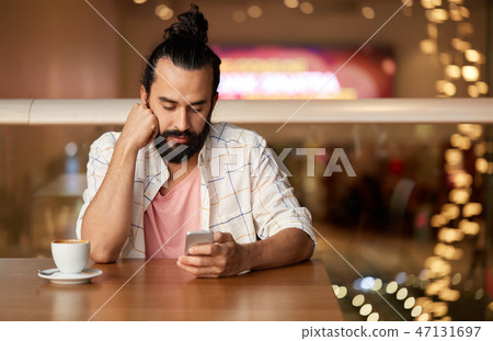 man with coffee and smartphone at restaurant man with coffee and smartphone at restaurant 47131697
