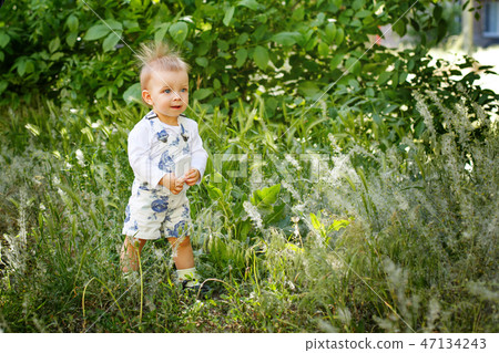 Little girl walking outdoors 47134243