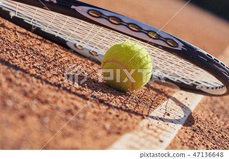 Tennis balls and racket on the court Tennis balls and racket on the court 47136648