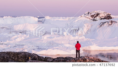 Travel in arctic landscape nature with icebergs - Greenland tourist man explorer Travel in arctic landscape nature with icebergs - Greenland tourist man explorer 47137692