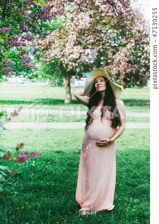 The beautiful pregnant woman with long dark hair The beautiful pregnant woman with long dark hair 47139255