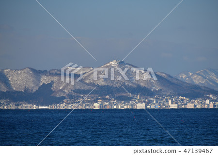 Taking a picture of the sunny Hakodate mountain landscape from the Shobo area of Hakodate city in winter Taking a picture of the sunny Hakodate mountain landscape from the Shobo area of Hakodate city in winter 47139467
