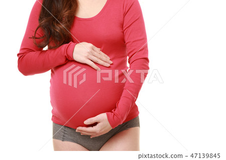 A pregnant woman with a pregnant woman touching his belly A pregnant woman with a pregnant woman touching his belly 47139845