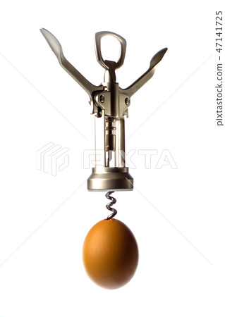 the corkscrew is screwed into the egg close-up the corkscrew is screwed into the egg close-up 47141725