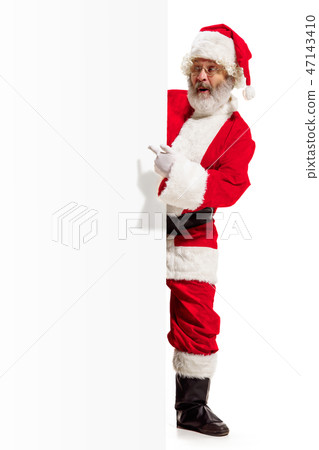 Happy Santa Claus pointing on blank advertisement banner background with copy space. Smiling Santa 47143410