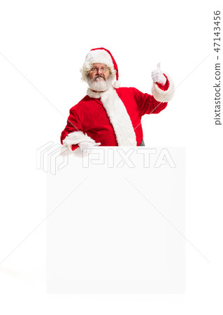 Happy Santa Claus pointing on blank advertisement banner background with copy space. Smiling Santa Happy Santa Claus pointing on blank advertisement banner background with copy space. Smiling Santa 47143456