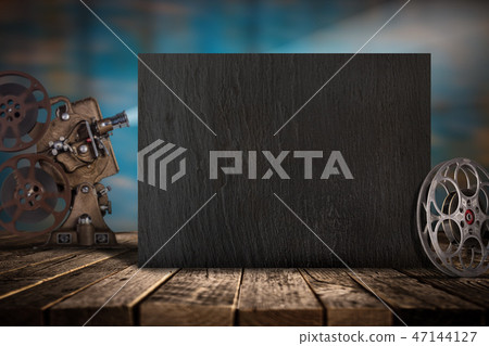 Cinema concept of vintage film reels, clapperboard and projector. 47144127