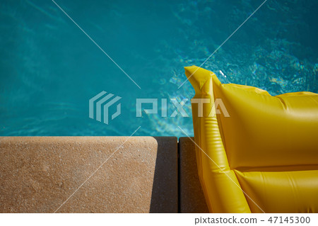 Beach accessories on the edge of the pool 47145300
