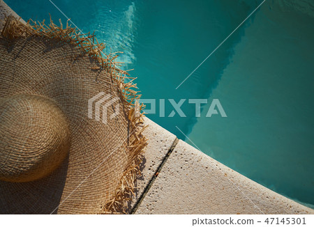sun hat on the edge of the pool. summer background sun hat on the edge of the pool. summer background 47145301