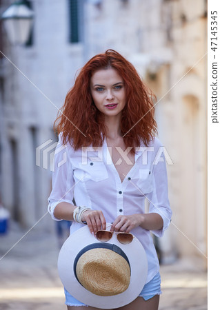 The woman tourist is visiting a small Croatian town Hvar. The woman tourist is visiting a small Croatian town Hvar. 47145345