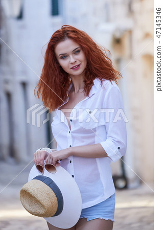 The woman tourist is visiting a small Croatian town Hvar. The woman tourist is visiting a small Croatian town Hvar. 47145346