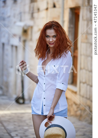 The woman tourist is visiting a small Croatian town Hvar. The woman tourist is visiting a small Croatian town Hvar. 47145347