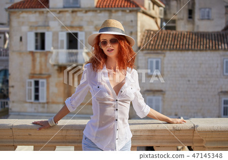 The woman tourist is visiting a small Croatian town Hvar. The woman tourist is visiting a small Croatian town Hvar. 47145348
