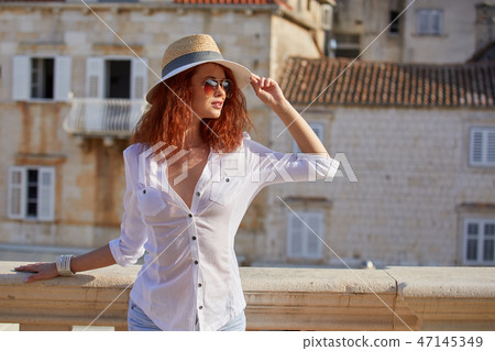 The woman tourist is visiting a small Croatian town Hvar. The woman tourist is visiting a small Croatian town Hvar. 47145349