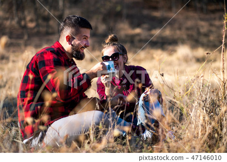 Couple having a cup of coffee outdoors 47146010