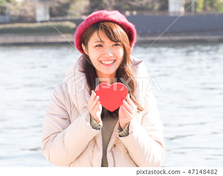 A woman with a red heart 47148482