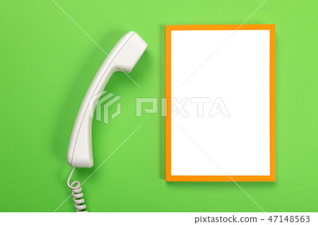Working table with telephone and frame with copyspace isolated on green background Working table with telephone and frame with copyspace isolated on green background 47148563