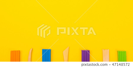 Set of colorful plasticine isolated on yellow background 47148572