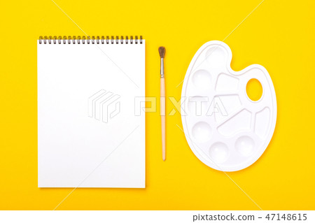 Plastic art palette with album for painting and brush on orange background Plastic art palette with album for painting and brush on orange background 47148615