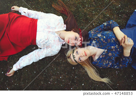Portrait of young beautiful women lying on  47148853