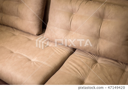 A close-up of a fragment of an expensive beige textile sofa in the room A close-up of a fragment of an expensive beige textile sofa in the room 47149420