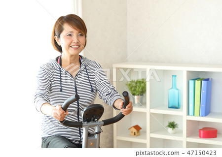 Woman training with fitness bike 47150423