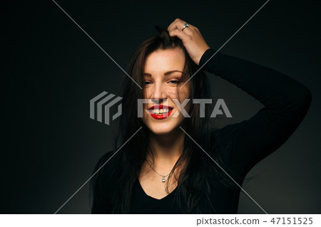 emotional girl smiling on a dark background emotional girl smiling on a dark background 47151525