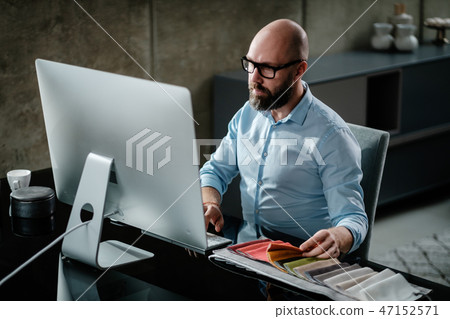 Middle-aged designer working in office Middle-aged designer working in office 47152571