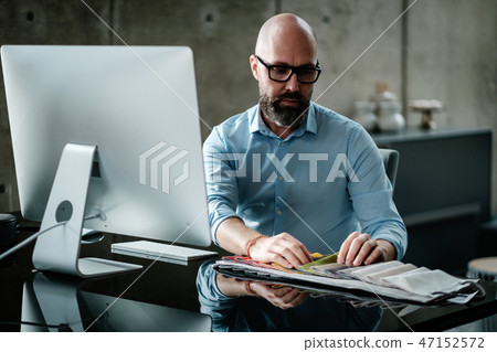 Middle-aged designer working in office 47152572