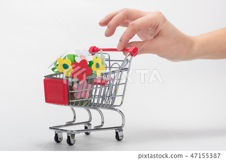 Hand carries a grocery cart with a children's  47155387