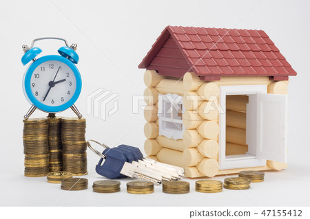 The alarm clock is on the stacks of coins, 47155412