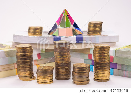 Financial pyramid, wads of money and stacks  47155426