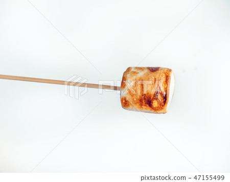 roasted marshmallows on a skewer on white background roasted marshmallows on a skewer on white background 47155499