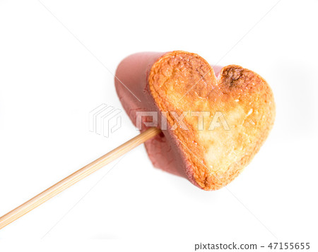 roasted heart form marshmallows on a skewer in female hand on white background roasted heart form marshmallows on a skewer in female hand on white background 47155655