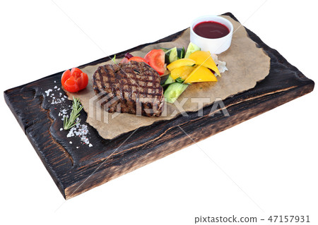 Beefsteak with vegetables and sauce on plate 47157931