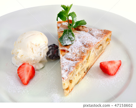 Charlotte of apples, with a scoop of ice cream. Charlotte of apples, with a scoop of ice cream. 47158602