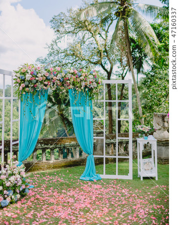 Wedding Arch with pink flowers, petals and blue Wedding Arch with pink flowers, petals and blue 47160337