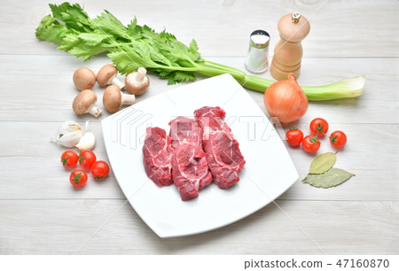 Image of ingredients, cooking, cooking and meat dishes. Beef sundae, celery, mushroom, onion, cherry tomatoes, garlic 47160870