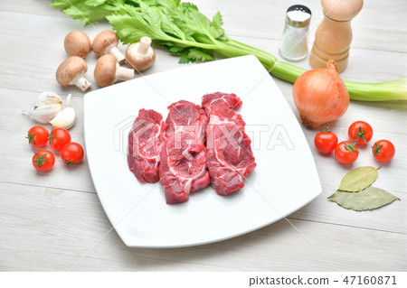 Image of ingredients, cooking, cooking and meat dishes. Beef sundae, celery, mushroom, onion, cherry tomatoes, garlic 47160871