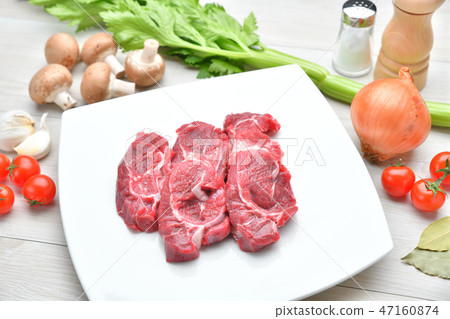 Image of ingredients, cooking, cooking and meat dishes. Beef sundae, celery, mushroom, onion, cherry tomatoes, garlic Image of ingredients, cooking, cooking and meat dishes. Beef sundae, celery, mushroom, onion, cherry tomatoes, garlic 47160874
